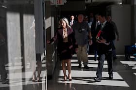 McDonald and members of her team walk through the courthouse hallway. They were not allowed to discuss the case publicly for months.